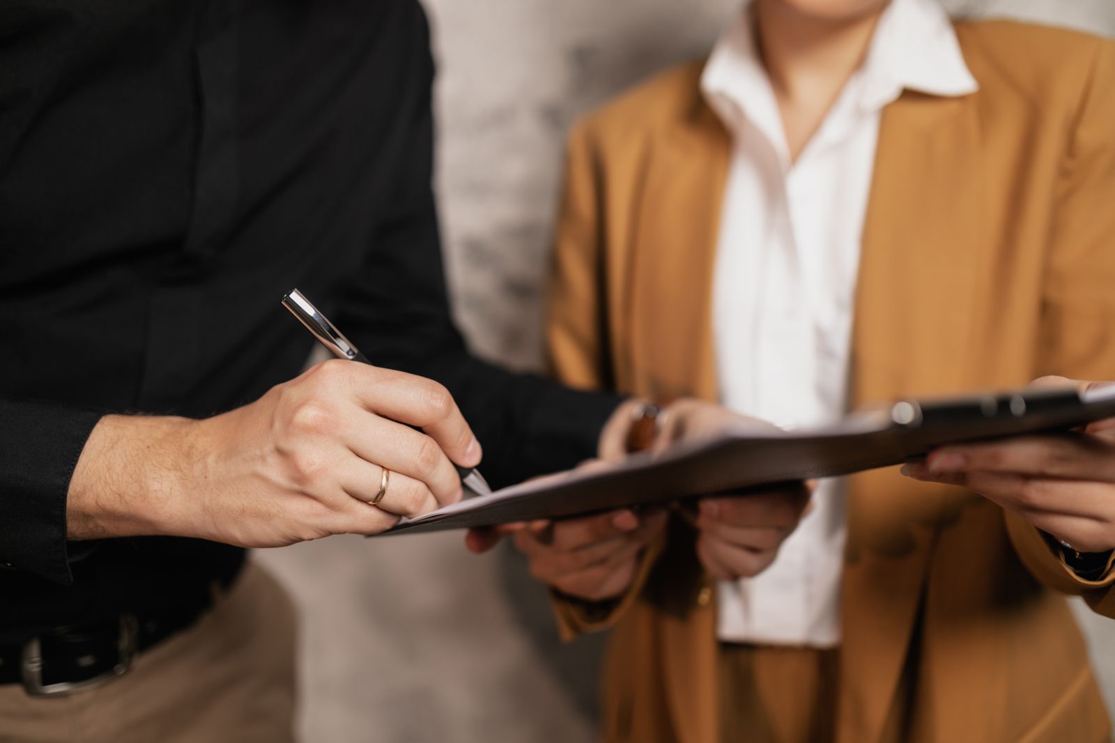 Mobile notary signing documents with a client on location